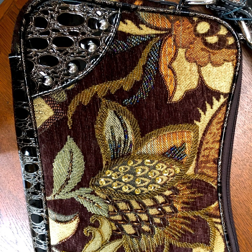 Beautiful/ embroidered Brand new/ w/plastic & w/hang tags, Mellow World handbag.